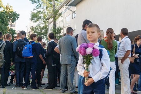 Ukraina.Kiev - September 1, 2016. The first-grader boy with flowers near the school.のeditorial素材