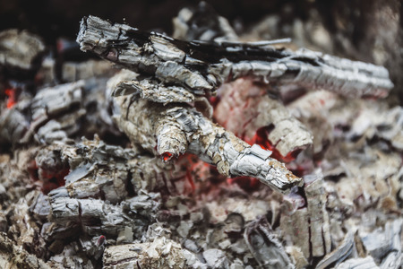 Remains of wood coal and ashes after the combustion of firewood.Burned charcoal and ash from fire.Coal and wood ashesの写真素材