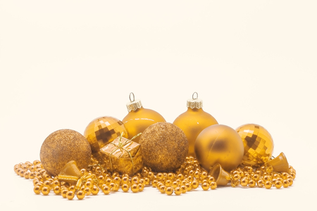 Christmas gold decoration, balls, beads, bell close up isolated.の写真素材