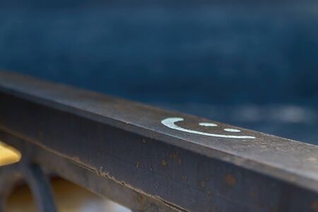 sign smile drawn on a stone wall, in blur.の写真素材