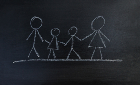 A family with parents and children drawn on a blackboard.の写真素材