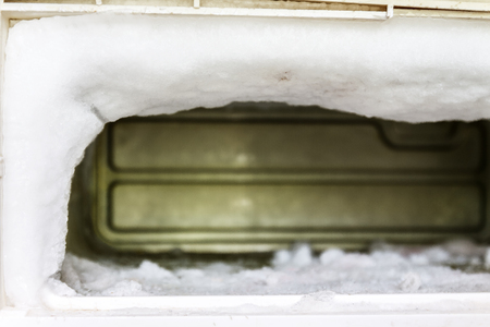 The freezer of a refrigerator is full of huge amounts of ice due to has no automatic defrost function.の写真素材