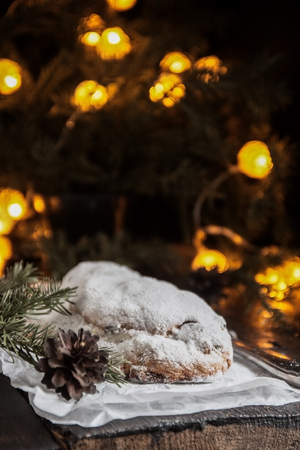 Dresden Stollen is a Traditional German Cake with raisins on a light knitted background.Gift for Christmas.Vintage style.Fruit cake for the Holidayの写真素材