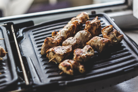 Pork-beef shish kebab prepared on a home electric grillの写真素材
