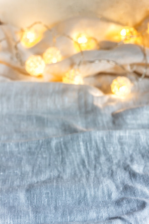 A garland background with ball lights on the folds of fabric in light gray. Copy space.の写真素材