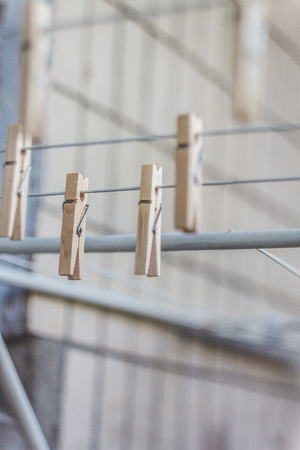 Wooden clothespins on a clothesline, blur, light photo. The concept of eco-consumption, the use of natural materials, awareness.の写真素材