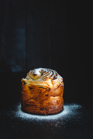 Easter cake with icing sugar on a dark background.