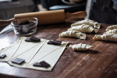 Cut the dough into triangles for croissants with chocolate.の写真素材