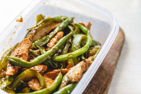 Chicken stew and green beans in plastic ovensの写真素材