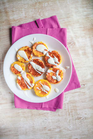 Curd cheesecakes, pancakes with sour cream on a plate and a light background. Top view. Close-upの写真素材