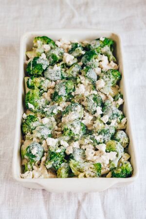 Chicken fillet and broccoli baked in cheese sauce in a baking di. Chicken fillet and broccoli baked in cheese sauce close-up in a baking dish. horizontal.の写真素材