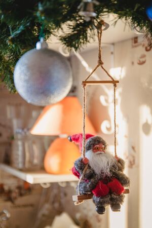 Santa Claus on a swing and skiing at the festive tree, Christmas toy, life style.の写真素材