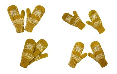 pair of yellow orange knitted mittens with christmas pattern isolated on white background. Collage of different mittens.の写真素材