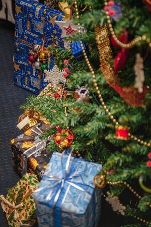 A variety of wrapped gifts under a festively decorated Christmas tree. Life style.の写真素材