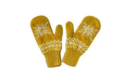 pair of yellow orange knitted mittens with christmas pattern isolated on white background. Collage of different mittens.の写真素材