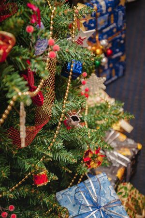 A variety of wrapped gifts under a festively decorated Christmas tree. Life style.の写真素材