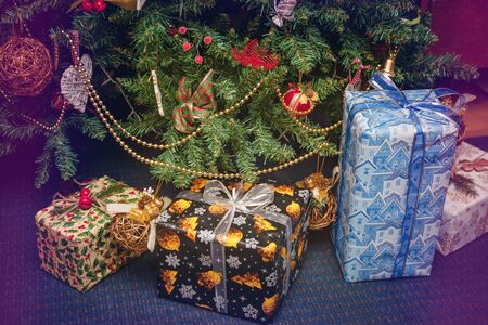 A variety of wrapped gifts under a festively decorated Christmas tree. Life style.の写真素材