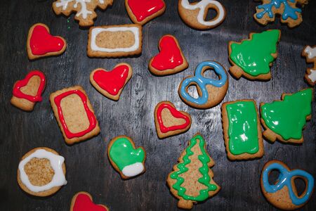 Christmas gingerbread with christmas decorations on dark stone background. Christmas baking background. Top view with copy spaceの写真素材
