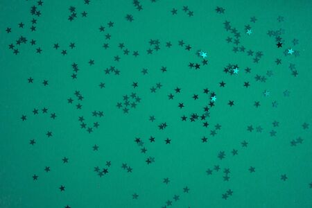 Blue-green-aquamarine background with festive shiny stars. Copy space. Postcard templateの写真素材