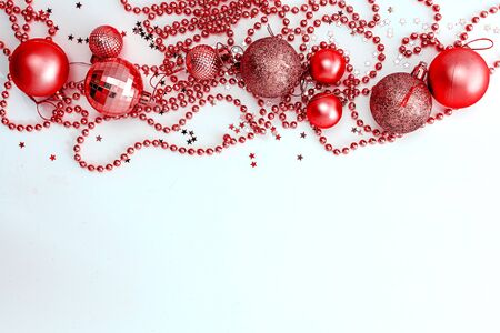 Christmas holidays composition, top view of red Christmas decorations and garland with lights on a yellow background with copy space for text. Blur. Flat lay. Winter, postcard template.の写真素材