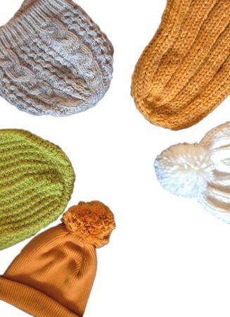 Different types of Knitted hat, yellow, green, white, gray on a white isolated background with copy space. View from above.の写真素材