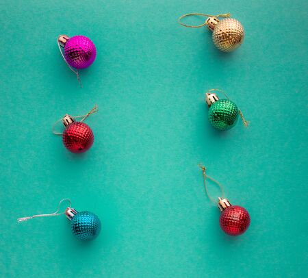 Christmas holidays composition, top view colored christmas decorations on green-blue-aquamarine background with copy space for text. Flat lay. Winter, postcard template.の写真素材