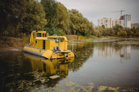 cleaning the lake with the help of a dredge boat court in Ukraine.の写真素材