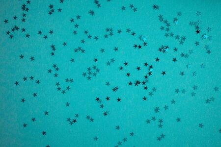 Blue-green-aquamarine background with festive shiny stars. Copy space. Postcard templateの写真素材