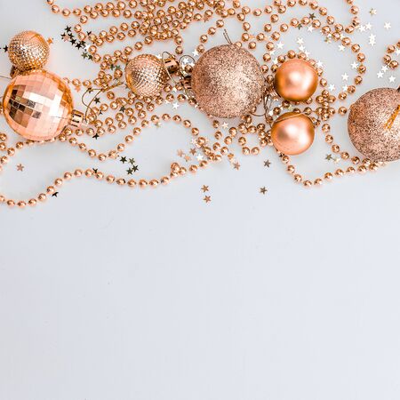 Christmas holidays composition, top view of gold Christmas decorations and garland with lights on a yellow background with copy space for text. Blur. Flat lay. Winter, postcard template.の写真素材
