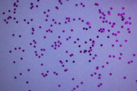 Pink-purple-violet background with festive glittering stars. Copy space. Postcard templateの写真素材