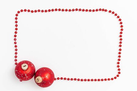 Christmas holidays composition, top view of red Christmas decorations and garland with lights on a yellow background with copy space for text. Blur. Flat lay. Winter, postcard template.の写真素材