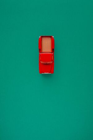 Red Retro car pickup on a blue-green-aquamarine background. Top view with copy space. Flat lay.の写真素材