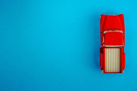 Red Retro car pickup on a blue-green-aquamarine background. Top view with copy space. Flat layの写真素材