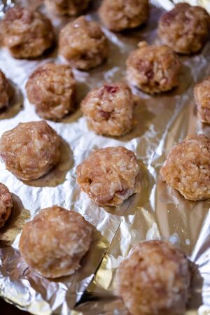 Raw meatballs on a dark baking tray. Concept, home cooking, healthy eatingの写真素材
