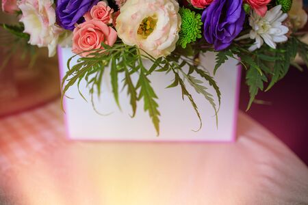 A festive oasis bouquet of diverse spring vibrant flowers in beautiful sunlight. Close-up. Copy space. Blur, selective focus.の写真素材