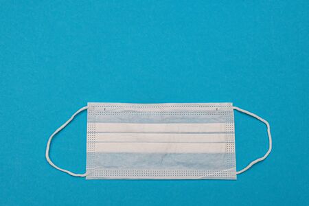 Medical disposable face masks on a blue background. coronavirus covid 19. World pandemic coronavirus. Stop the pandemic. Health and prevention of influenza and an infectious outbreak. Quarantine. New 2019 nCoV virus.の写真素材