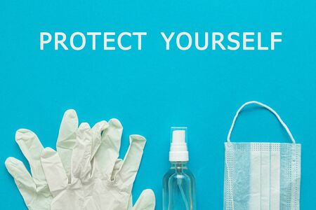 medical protective mask, gloves, alcohol disinfector on a blue background with the text PROTECT...