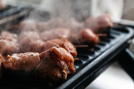 Skewers on skewers from raw meat of pork and beef, chicken cooked on a home electric grill. Top...