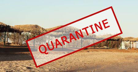 Crisis in the tourism industry due to outbreaks of coronavirus. Stopped traveling, red stamp text. Cancelled, quarantine text on a tropical resort with palm trees, pool, water slides, entertainment. Cancellation of a cruise due to the Covid-19 pandemicの写真素材