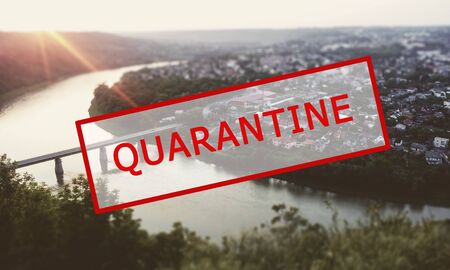 Crisis in the tourism industry due to outbreaks of coronavirus. Stopped traveling, red text QUARANTINE against the blue sky of the city, town. Kamyanets-Podilsky, Zalishchyky, Ukraineの写真素材