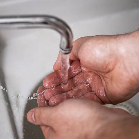 Mens hands are showing ways to wash their hands with a cleaning gel to prevent infectious diseases and prevent the virus.の写真素材