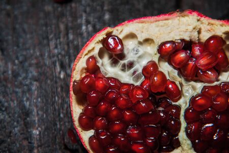 Broken pomegranate fruit on a dark background. close-up. view from aboveの写真素材