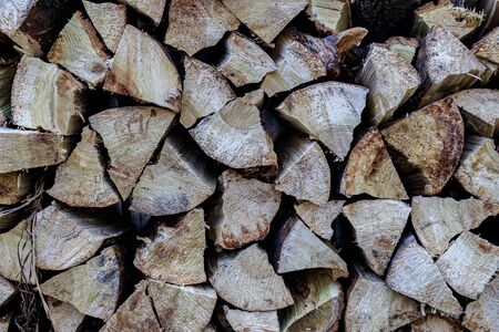 Background with stacked stacked firewood. Winter blanks for collapse and heatingの写真素材