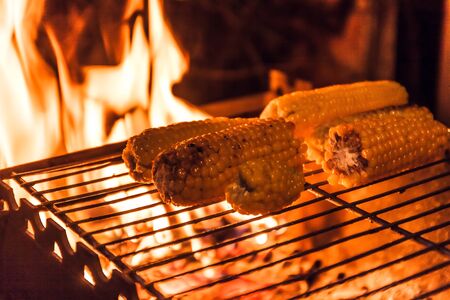 ears of corn on a grill over high heat, night shooting.の写真素材