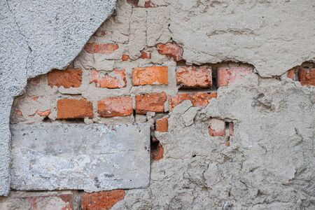 background from the texture of an old brick wall with ruined concreteの写真素材