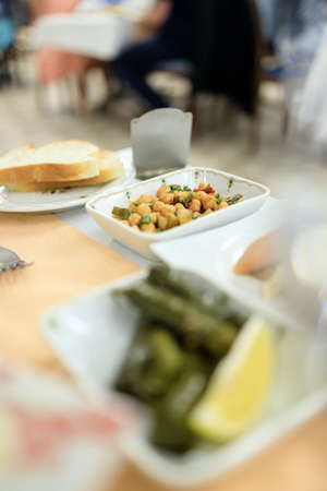 Traditional Turkish appetizers, chickpeas, dolma served in the restaurantの写真素材