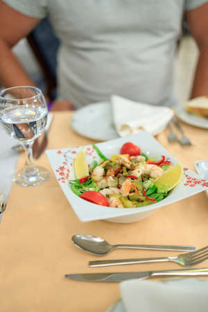 Turkish style salad with shrimps, gherkins and vegetables on a plate. Serving in a Turkish restaurantの写真素材