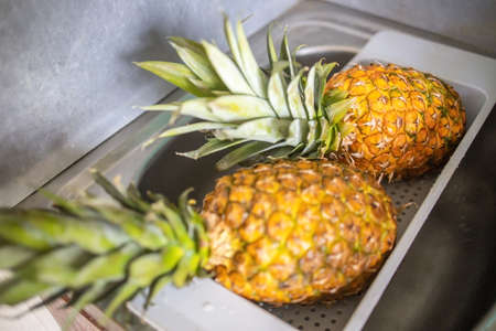 two ripe and juicy pineapples lie in the dryer after washing.の写真素材