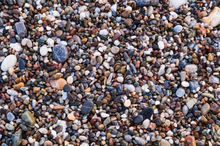 Background of colored sea pebbles on the beach of Alanya, Turkey. Seamless textureの写真素材