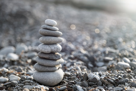 Pyramid of gray pebble stones on the beach of Turkey at sunrise. Zen concept, relaxation. calmness, balanceの写真素材